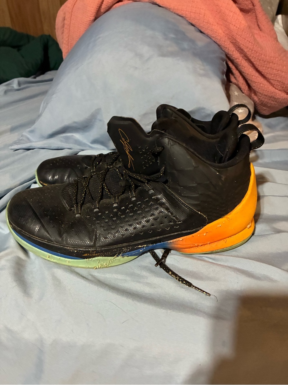 Black Basketball Jordans with Orange Heel Accent
